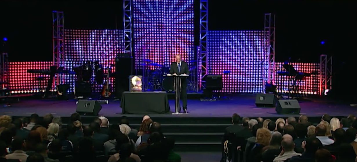 Dr. Peter J. Daniels speaking to a packed audience